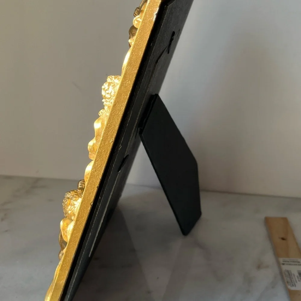 Large gilded Cherub Picture Frame holds 5”x7”. Rare